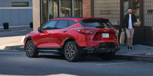 A photo of a red 2025 Chevrolet Blazer parked on a city street near Clinton Township