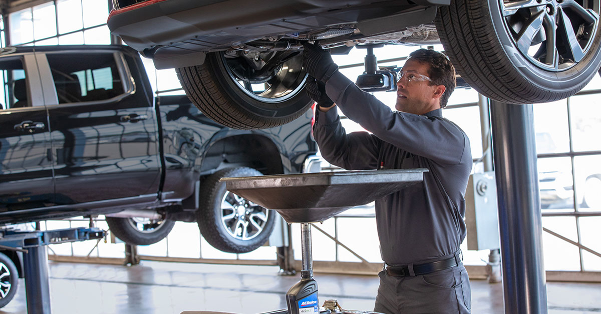 Chevrolet Service Technician working on a Chevy vehicle