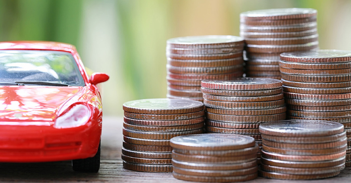 Car next to a stack of coins