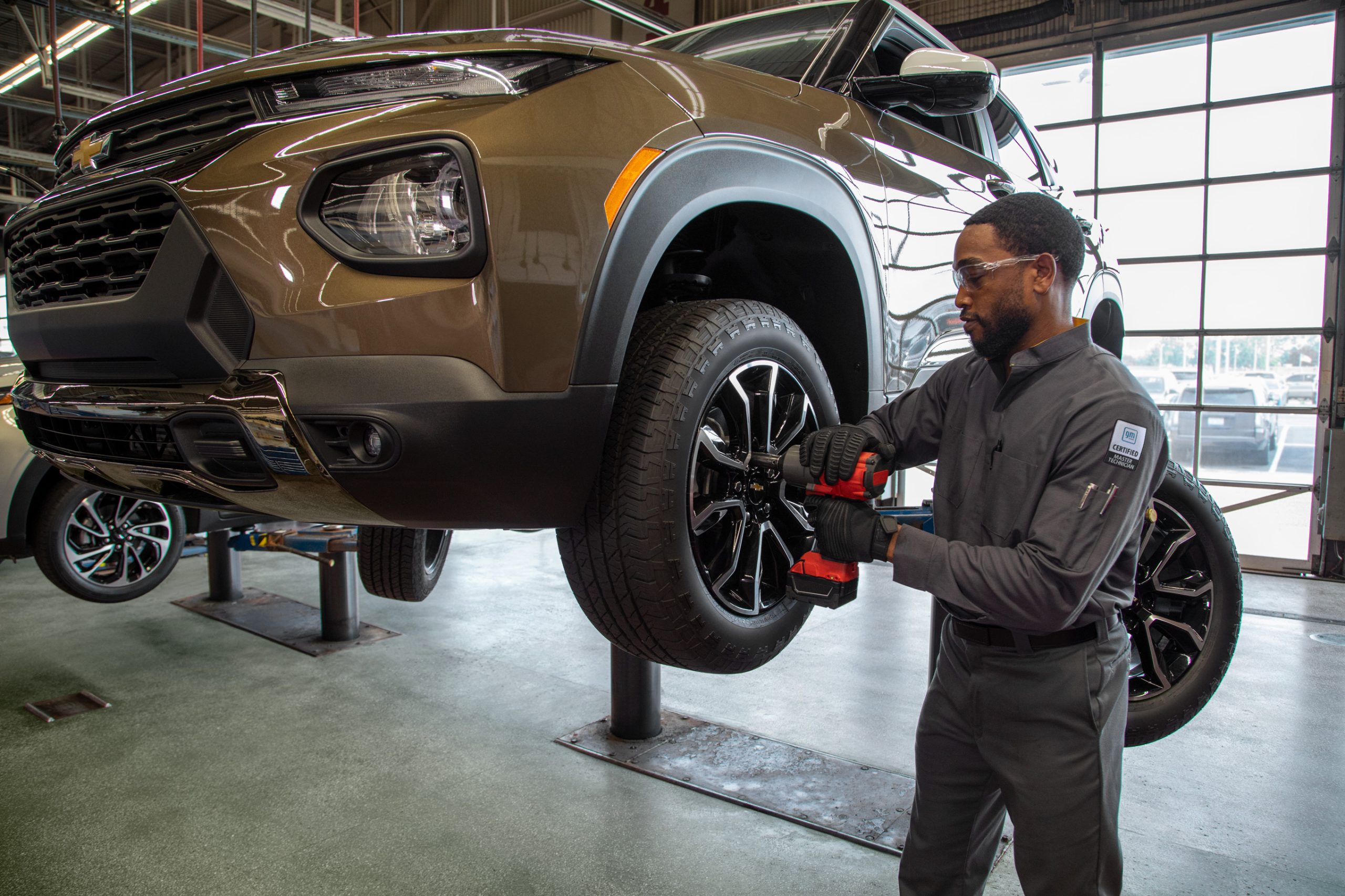 Chevy service technician rotating tires