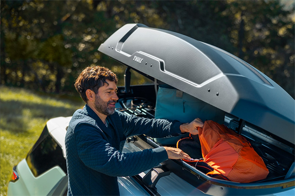 Person using a Chevrolet accessory for rooftop storage on a Chevy Equinox