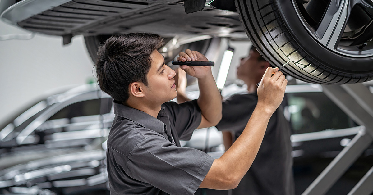Chevy service technician inspecting tires
