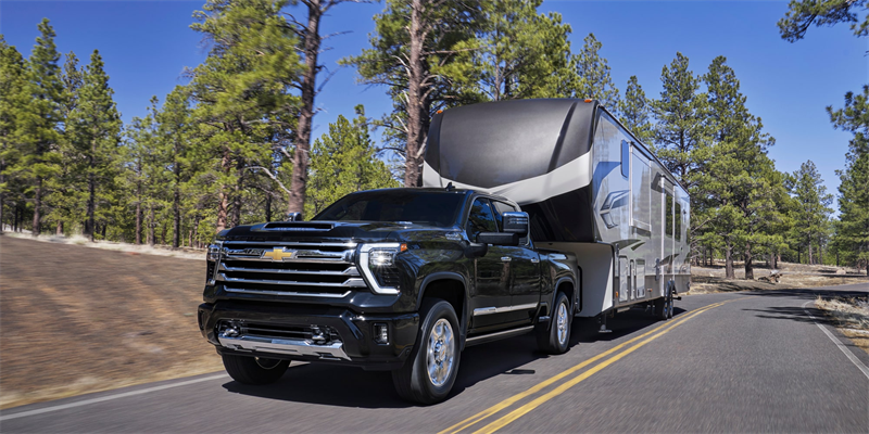 2026 Chevrolet Silverado HD towing a camper